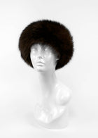 Brown fur hat on a mannequin head against a white background