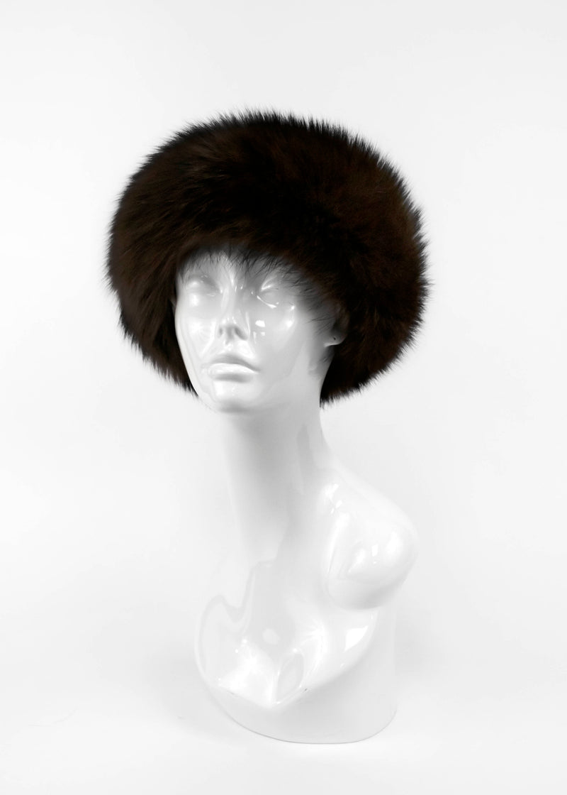 Brown fur hat on a mannequin head against a white background