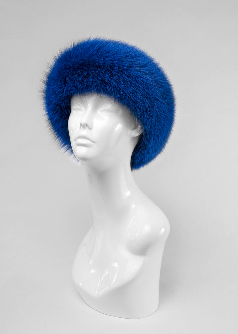 Blue fur hat on a mannequin head against a gray background