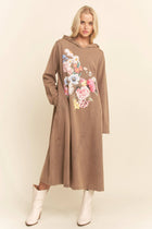 Woman wearing a brown hoodie dress with floral design on a beige background