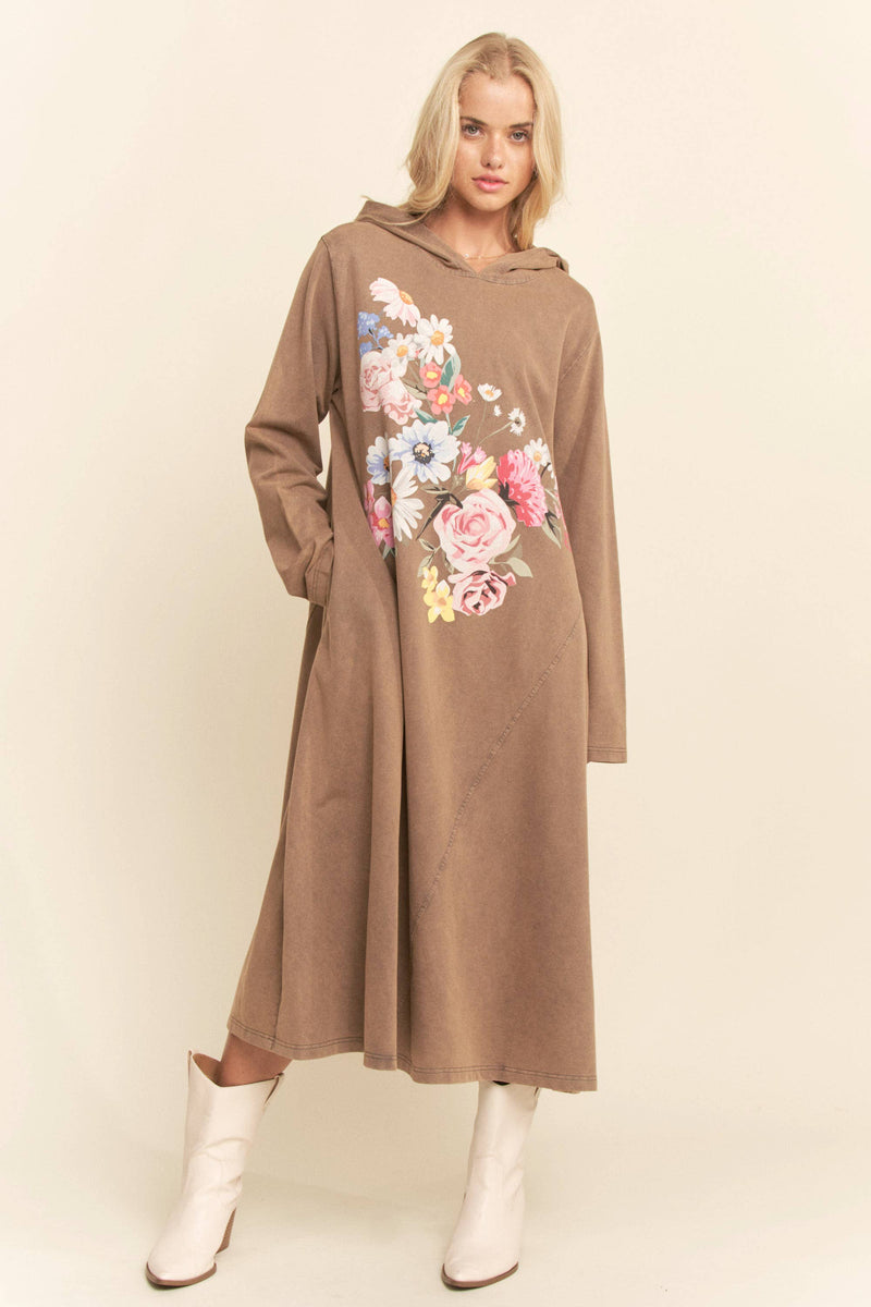 Woman wearing a brown hoodie dress with floral design on a beige background