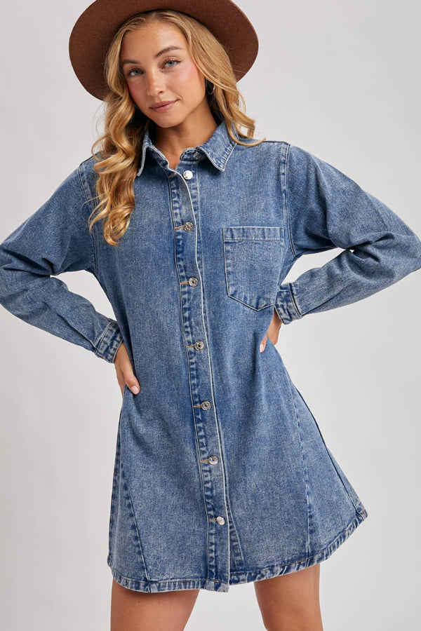 Woman wearing a denim dress with a plain background